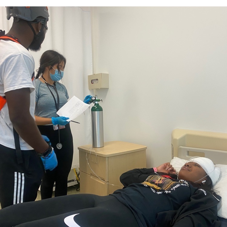 EMT students performing patient assessment