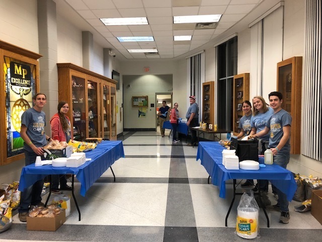 Students prepare to serve the evening's meal