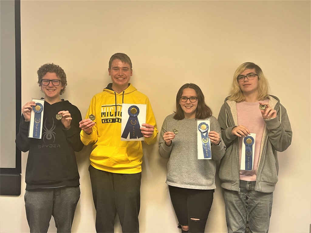 Quiz Bowl team members (4) hold up their championship ribbons