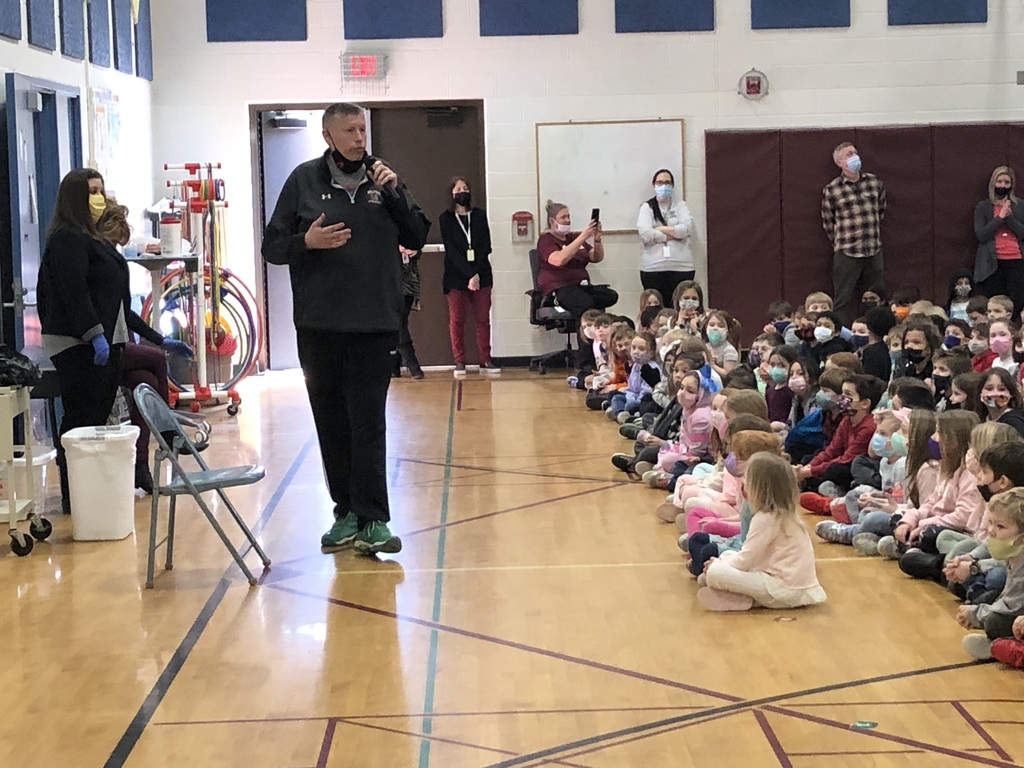 teachers and students at an assembly in the school gym