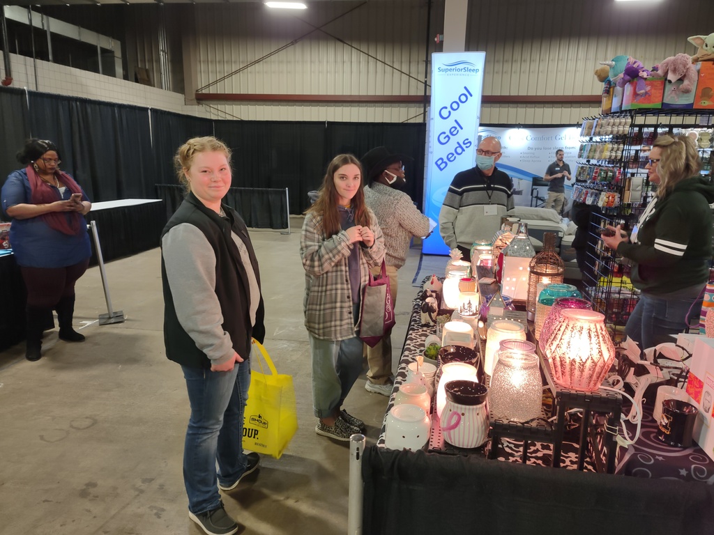 two students looking at a booth 