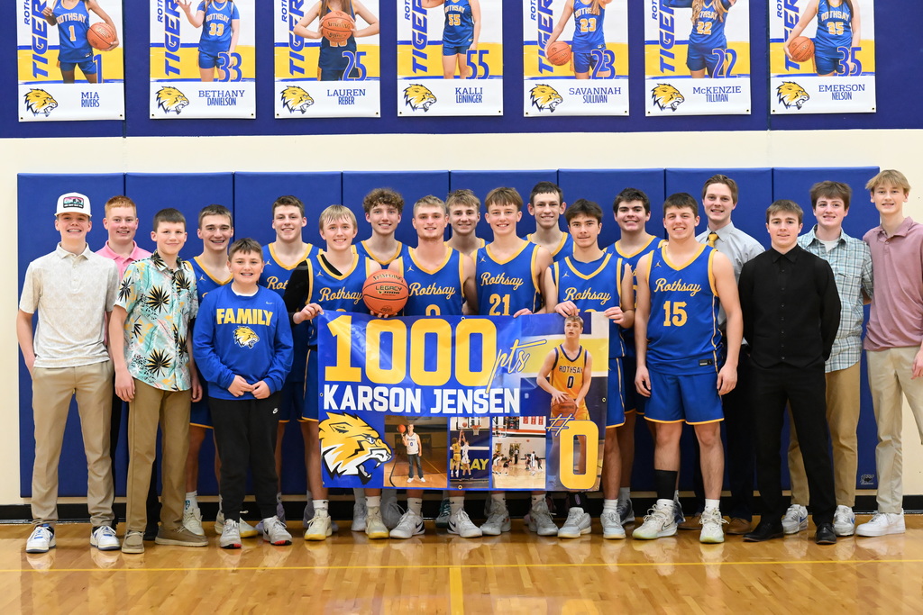 The basketball team celebrating Karson's achievement with a team picture.