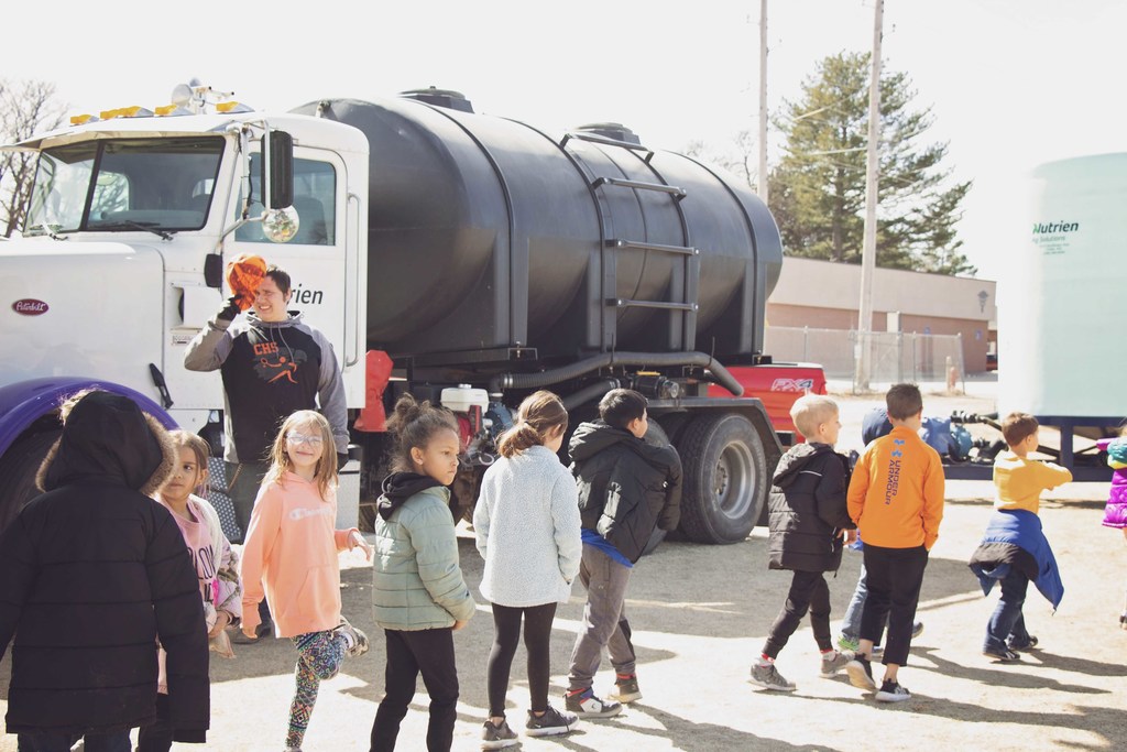 Grade School students tour farm and agriculture vehicles.