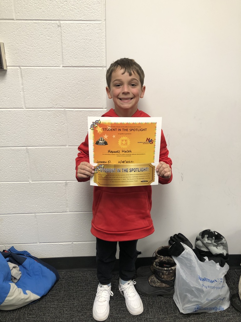 boy holding a certificate and movie tickets