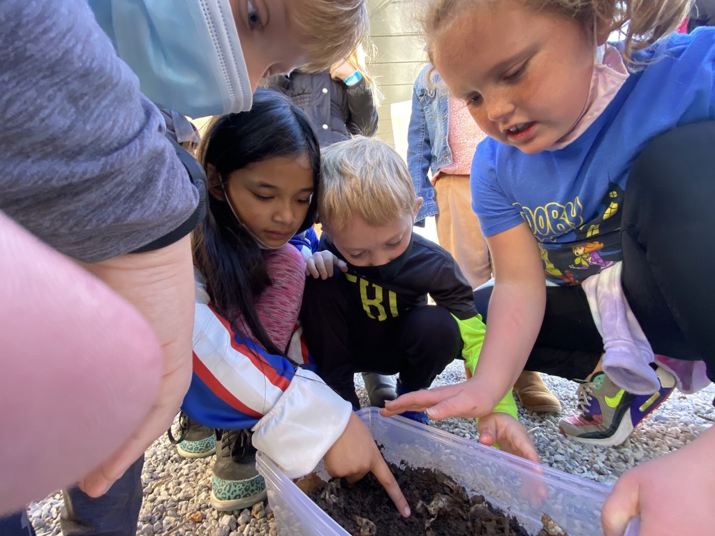 Students working in the garden at Butterfield Trail Elementary with Mrs. Betty Metcalf.