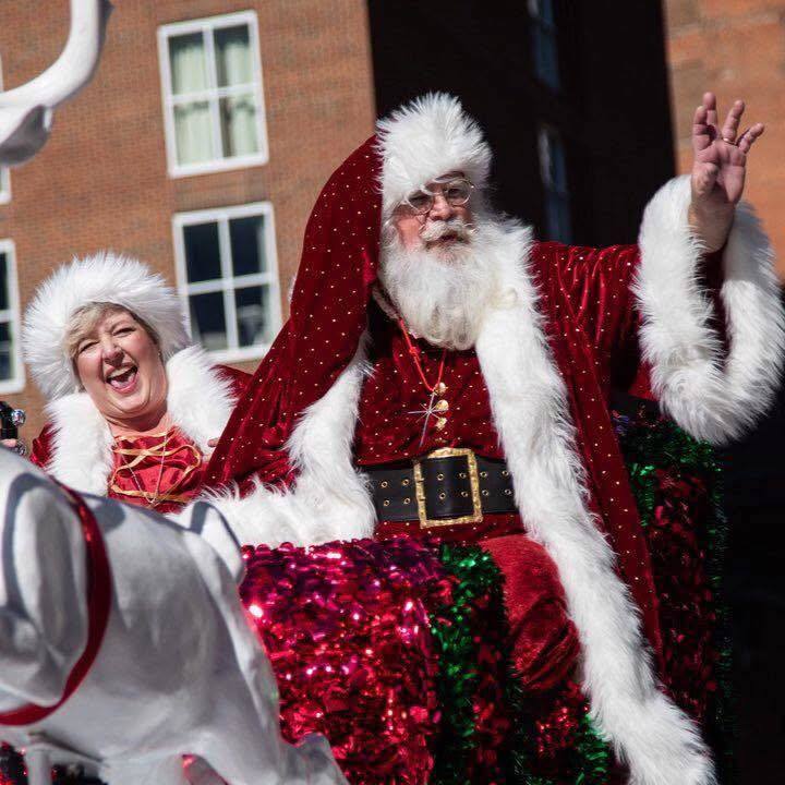 Two people dressed as Santa Calus and Mama Claus