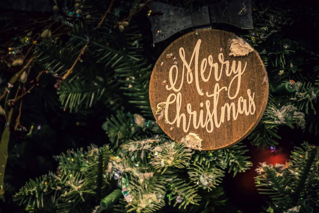 wooden sign saying merry christmas