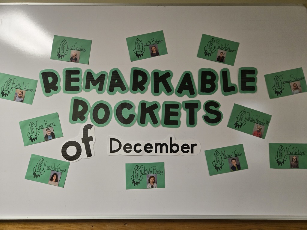 board with student pictures on it