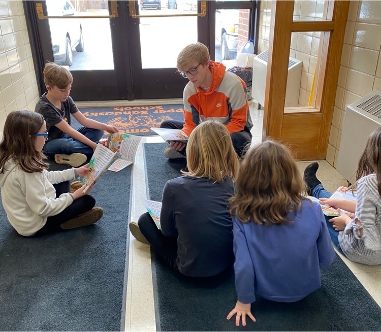 HS students reading to kids