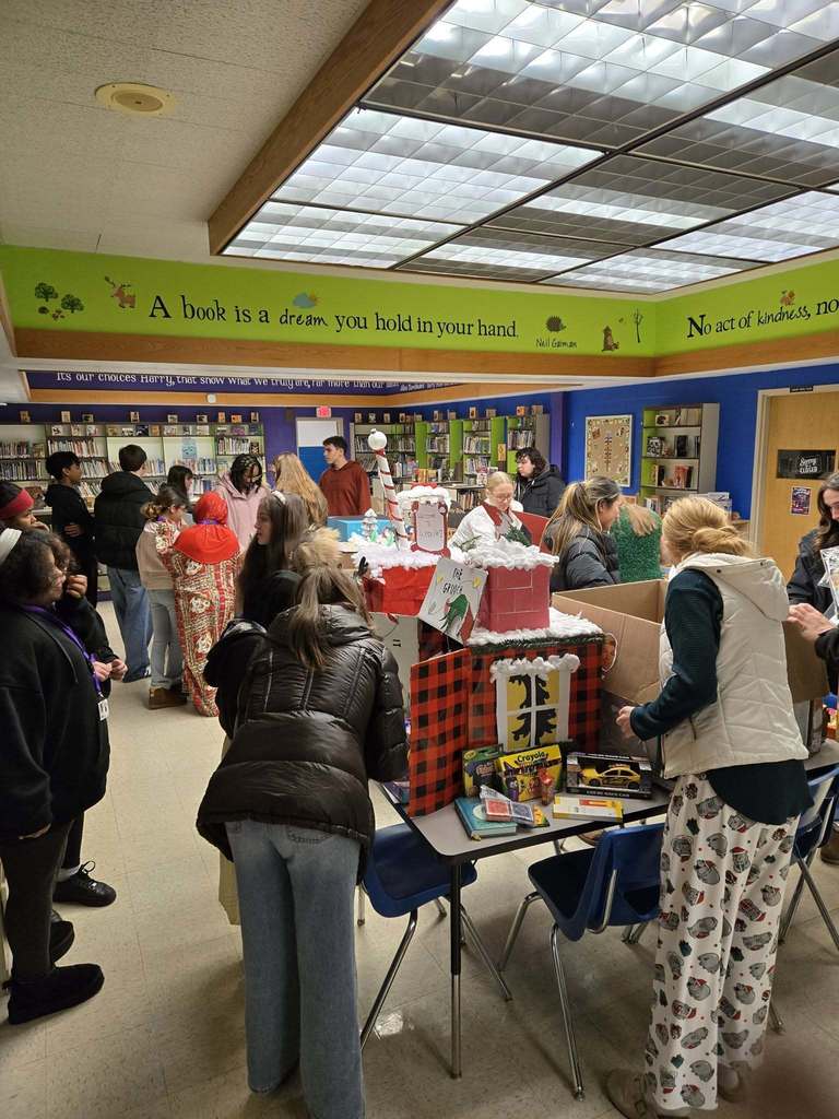 A photo of people standing and looking at the different art made.