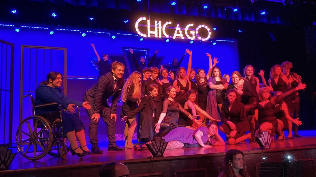 A group shot underneath a CHICAGO sign.