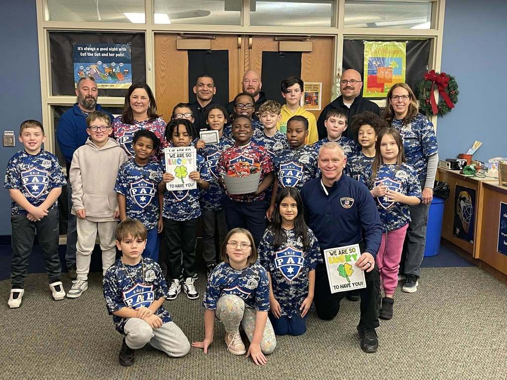 Group of students standing with two females and three City Police Officers.