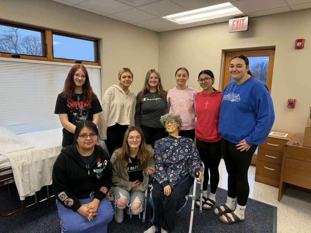 Group photo of 8 girls with the CNA mannequin