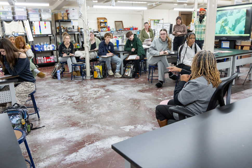 Students and adults in an art room. 