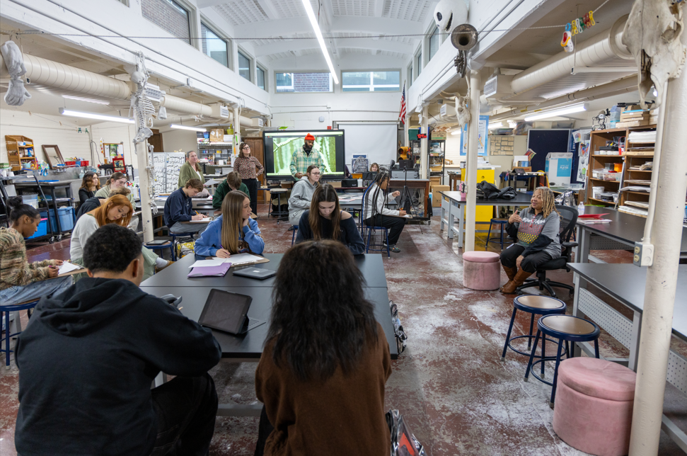 Students and adults in an art room. 