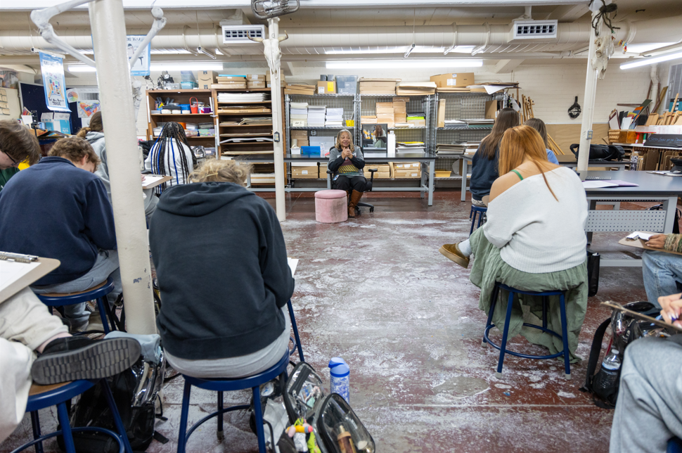 Students and adults in an art room. 