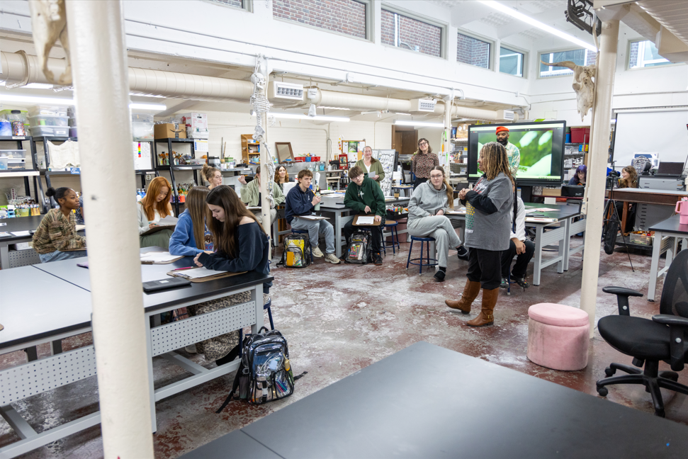 Students and adults in an art room. 