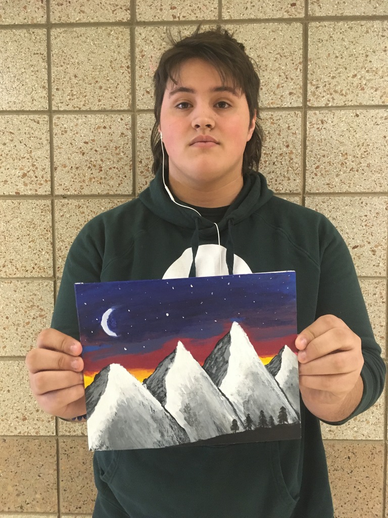 male student holding a mountain painting