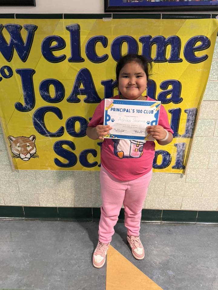 Young girl in all pink and holding her certificate.