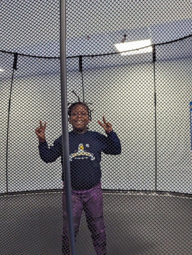 Young boy on a trampoline.