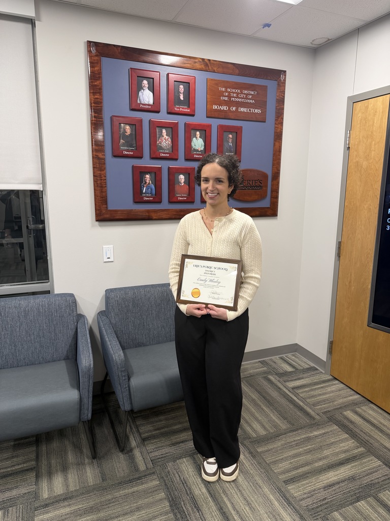 Women standing and holding her certificate. 
