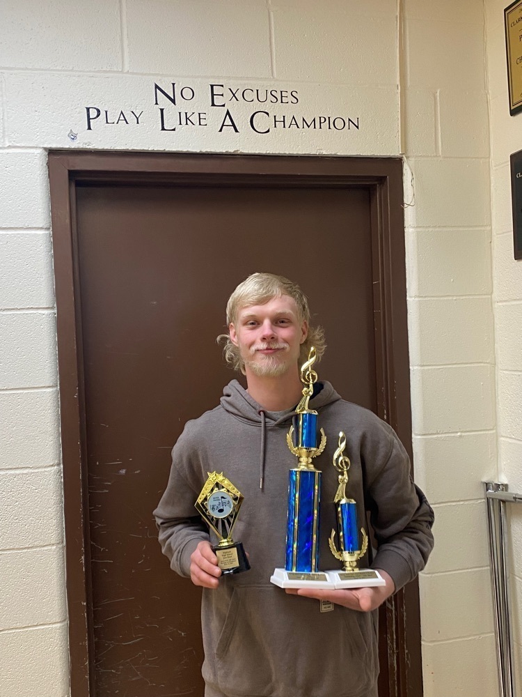 James Stutheit wins Outstanding Soloist on the day -- Pictured holding his trophy with the Jazz Ensemble trophies also.
