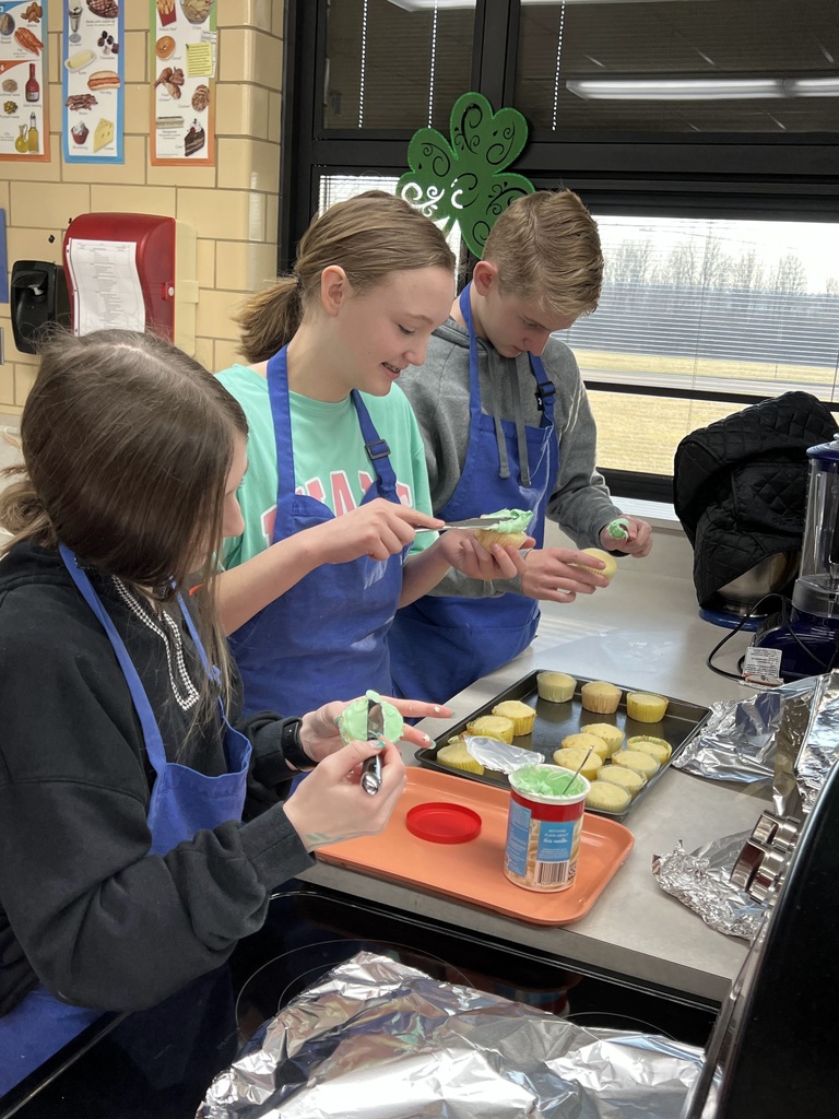 Three TMS working together to decorate cupcakes.