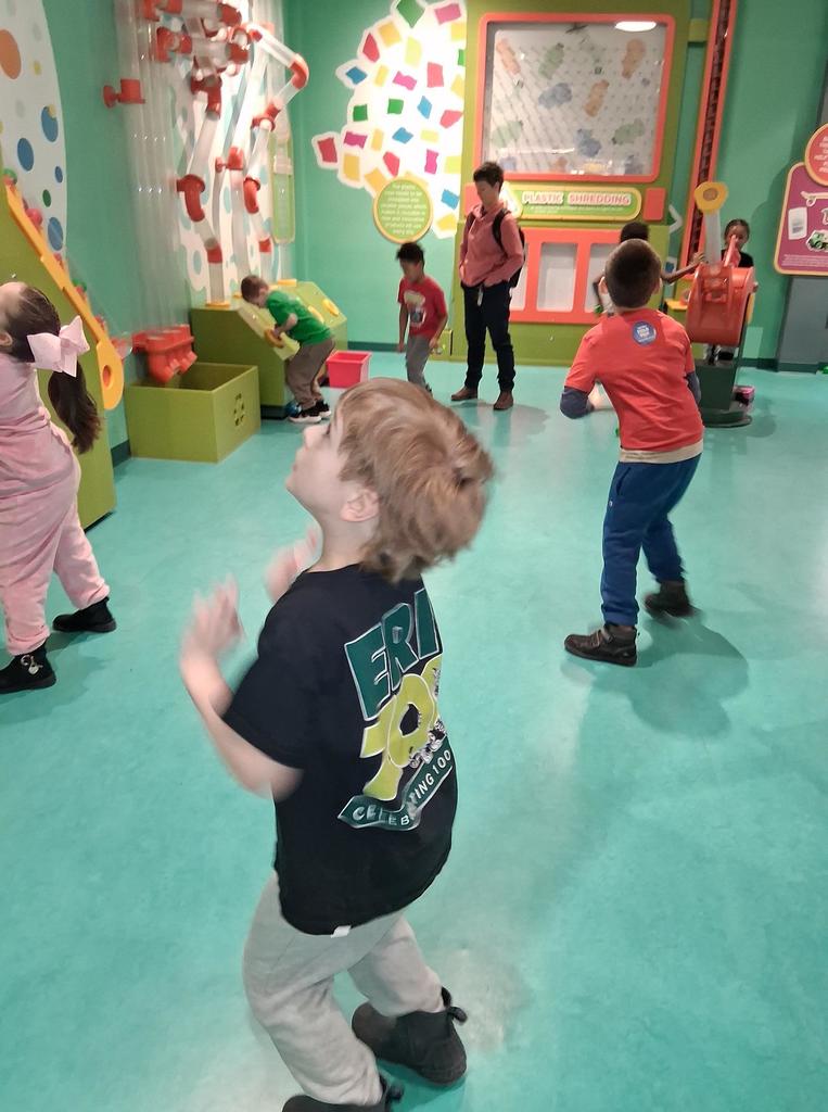 Kids playing in a green room.