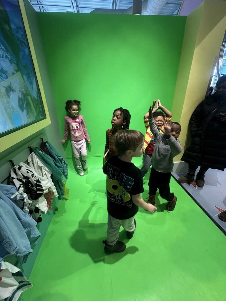 Kids playing in a green room.