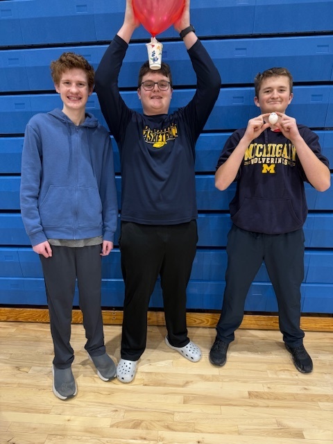 a group of boys showing off their egg that didn't break