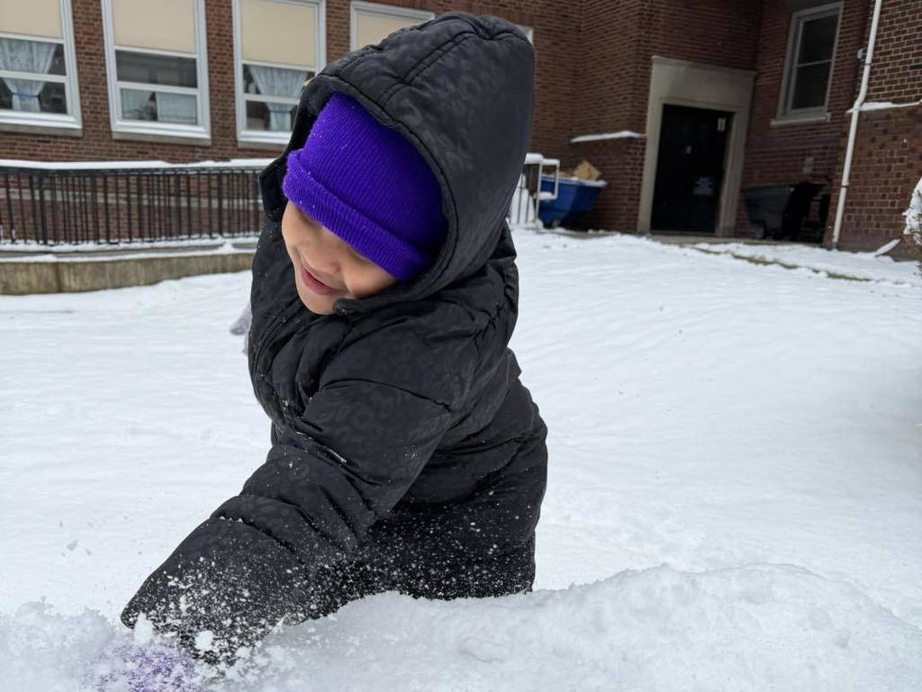 Young child playing in the snow. 