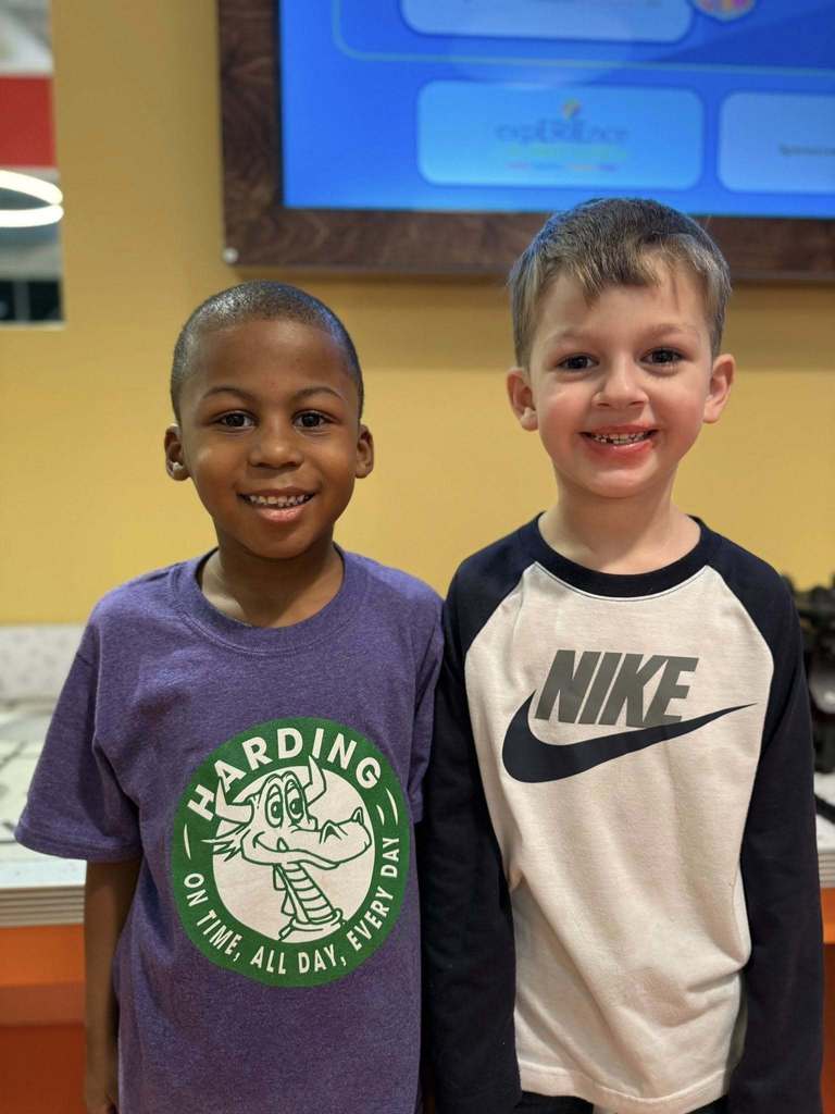 Two young boys smiling. 