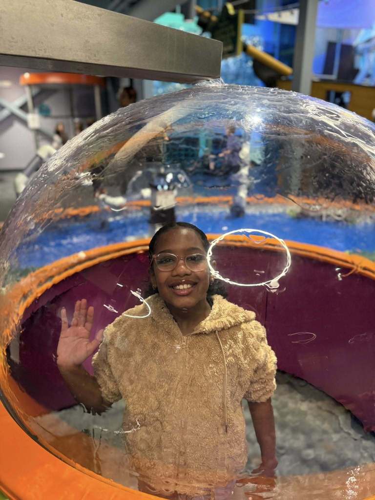 Young boy with glasses in a bubble. 