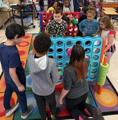 Kids playing big connect four.