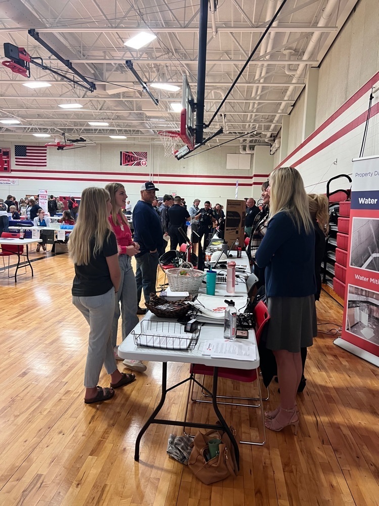 students talking at a booth 