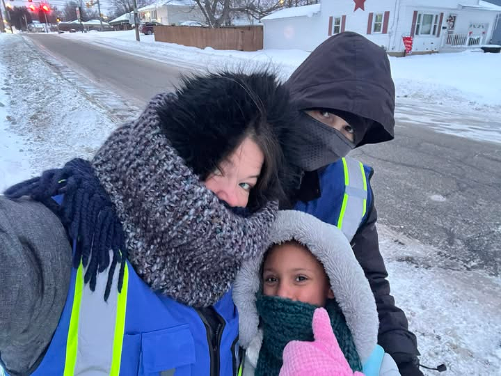 Three individuals dressed in winter gear outside.