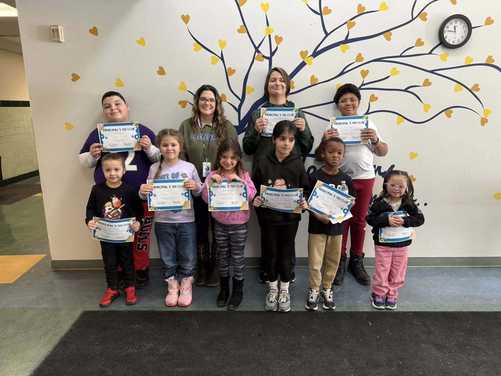 Group photo of students holding their certificates and a staff member.