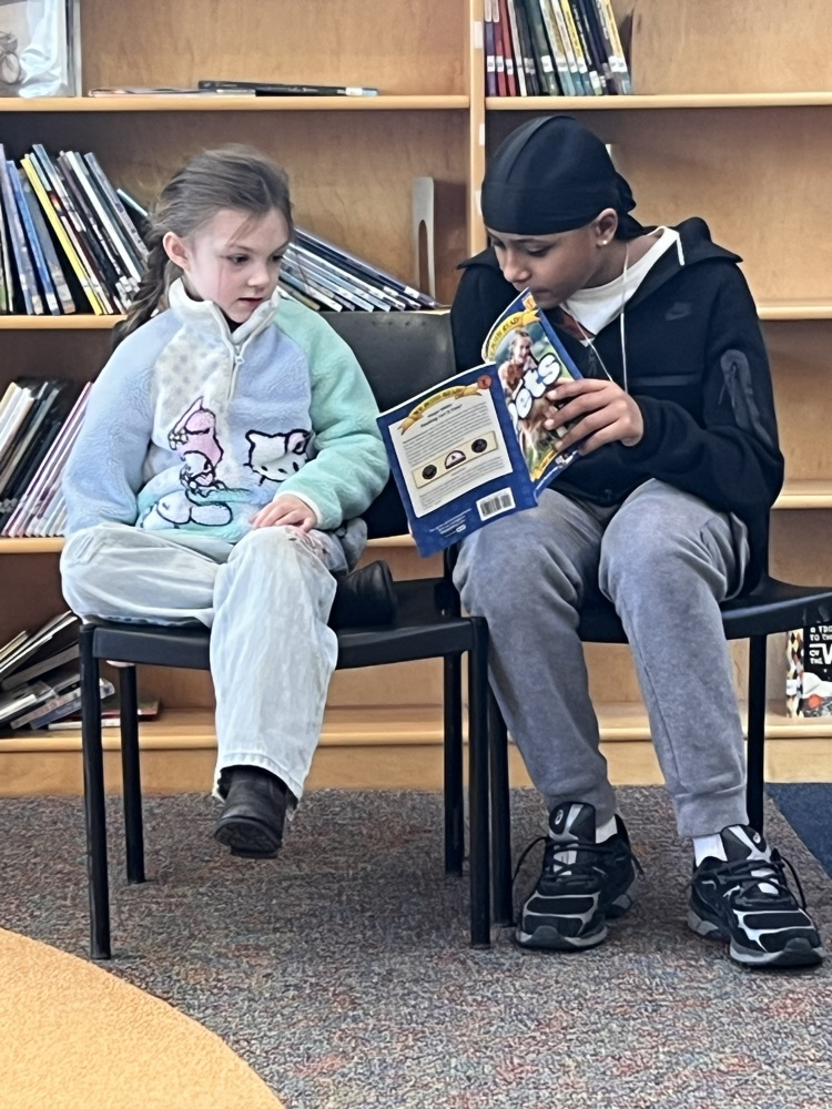 Ernie Davis Academy students reading to primary aged students