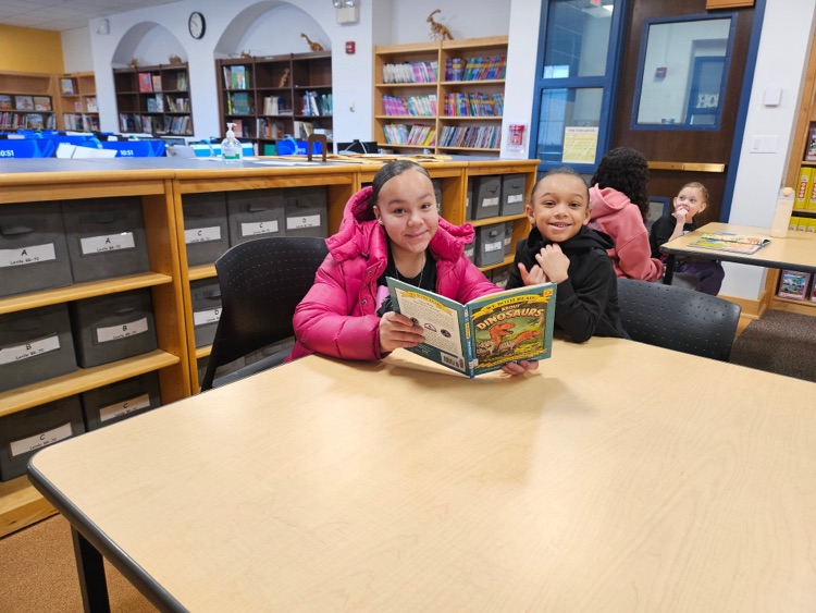 Ernie Davis Academy students reading to primary aged students