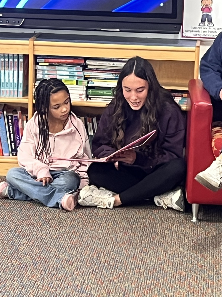 Ernie Davis Academy students reading to primary aged students