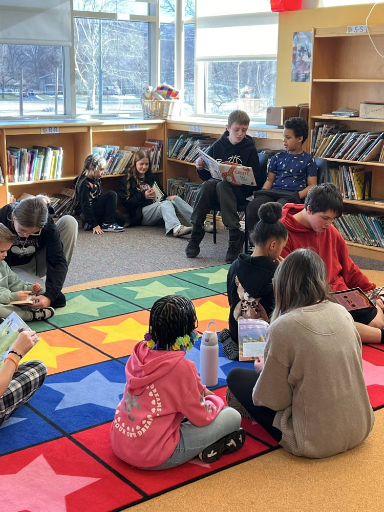 Ernie Davis Academy students reading to primary aged students