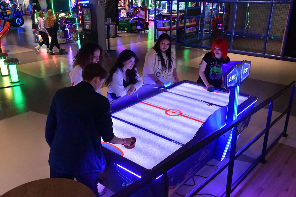 students playing air hockey