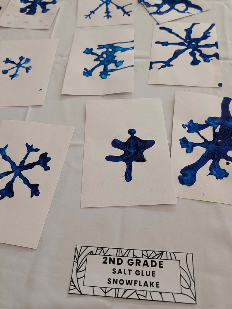 Blue snowflakes painted on paper.