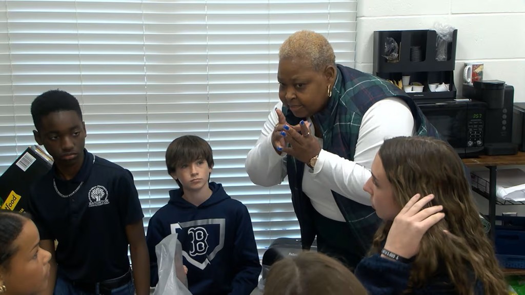 Principal discussing a fundraiser with students