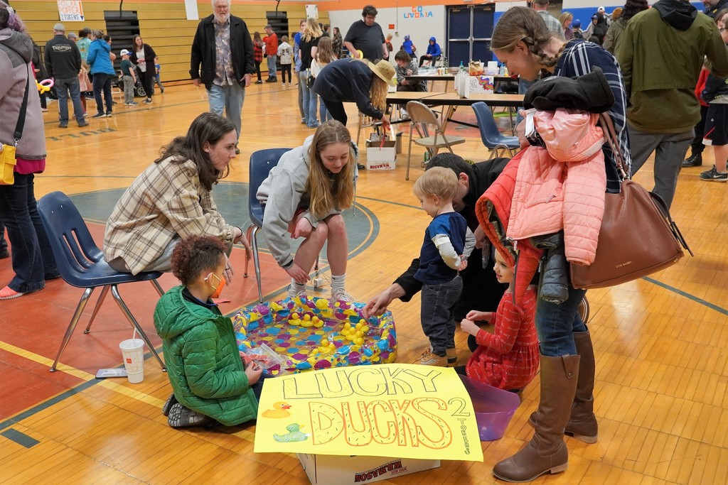 students playing game lucky ducks with rubber ducks in blow up kiddie pool