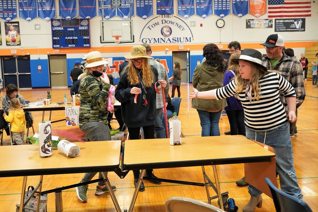 students playing a bottle knock down game