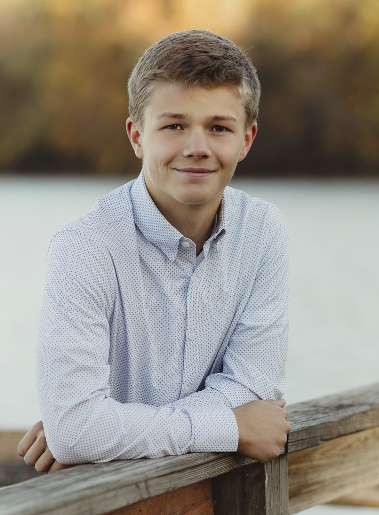 Photo of Bryan Jacobson leaning on railing with lake in background