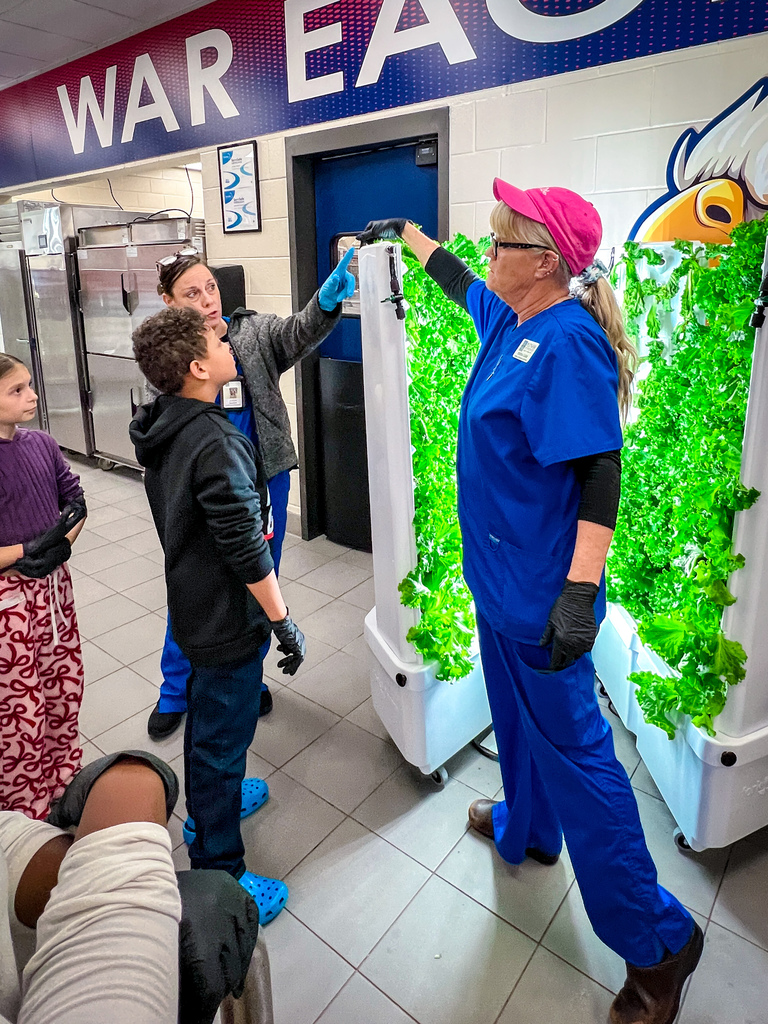 PCES students learning about PCCSS" HydroFarms and harvesting lettuce for their salad bar.