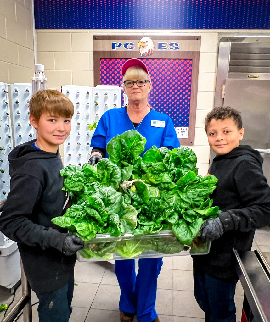 PCES students learning about PCCSS" HydroFarms and harvesting lettuce for their salad bar.