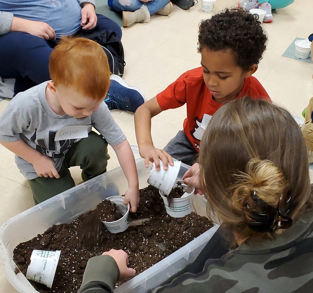 WBE PreK students planting shamrocks